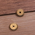 Golden steampunk gear alloy pendant connector for DIY jewelry making on wood background - Approximately 1.4g Of Ancient Gold