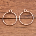 Two rose gold round open bezel charms for DIY jewelry making on wooden background - Round Style / Rose Gold