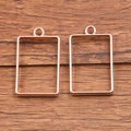 Set of two rectangular rose gold plated alloy pendants with hollow frame and top rings - Rectangular Style / Rose Gold