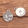 Vintage silver Aquarius constellation pendant with zodiac symbols on a wooden background - Antique Silver - Aquarius