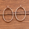 Two oval rose gold DIY jewelry pendants with smooth polished finish on wood surface - Oval Style / Rose Gold