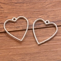 Set of two hollow heart-shaped alloy pendant frames for DIY jewelry making in gold finish - Heart Style