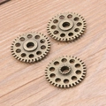 Three bronze alloy steampunk gear charms on light wood background for DIY jewelry making - Ancient Bronze 3.6g