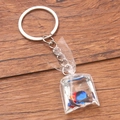 Transparent resin bag keychain with a realistic blue fish pendant on wood background - Blue Surgeonfish #6