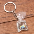 Blue and yellow tropical fish resin keychain bag pendant on dark wood background - Yellow Blue Fish #7