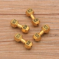 Macro shot of gold dumbbell beads with Live and Lift engraving for DIY jewelry making - Large / Antique Gold