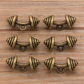 Detail view of vintage bronze dumbbell pendants on wooden background for DIY jewelry making - Dumbbell Style (20E03) / Antique Bronze