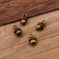 Set of four vintage bronze acorn pendants made of alloy for DIY necklace jewelry making - Bronze