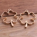Two rose gold clover shaped hollow pendant charms for DIY jewelry on wood background - KC Gold