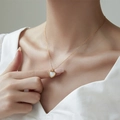 Golden heart pendant necklace with white mother of pearl inlay on female model - White Agate Necklace