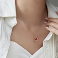 Minimalist gold necklace with heart red agate pendant shown on woman neck - Red Agate Necklace
