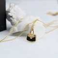 Quilted purse pendant necklace in 18K gold plated titanium with black inlay details - Gold
