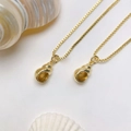 Close-up of golden conch pendants with cubic zirconia on elegant box chains - Gold Conch Necklace (25110216)