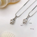 Detail of silver conch pendant necklace showing dimensions 12mm by 7mm and 1g weight - Silver Dotted Shell Necklace (25110216)