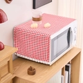 Red checkered dust cover for microwave with white fringe pom poms in a home setting - Red Plaid