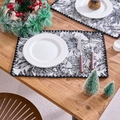 Detail of jacquard placemat with black and white botanical prints and wavy scalloped edges - Jacquard Black Coconut Tree Black Edge