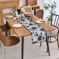 Elegant black and white floral jacquard table runner on a wooden dining table - Jacquard Black Graffiti Style with Black Scalloped Edge