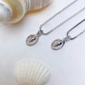 Silver marine necklace with shell-embossed oval pendant and delicate box chain - Silver Embossed Shell Necklace (25110216)