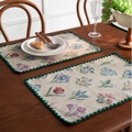 Blue jacquard table runner with floral embroidery on a vintage dark wood dining table - Jacquard Cream Hyacinth Embroidery with Green Scalloped Edge