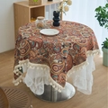 Round paisley tablecloth with warm tones and beige fringes layered on lace fabric - Paisley Jacquard Style (Curved Tassel)