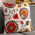 Ethnic Suzani floral embroidered linen pillowcase on a grey sofa in a cozy home setting - 30x45cm / Sunflower Style