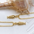 Elegant gold-plated fish pendant necklace with box chain on a sea shell background - Gold Small Fish Engraved Necklace (25110216)