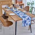 Blue and white floral table runner with elegant pom-pom lace trim on wooden desk - Jacquard Blue Graffiti Style with Blue Scalloped Edge