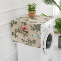 Detail of floral print dust cover with side storage pockets and white pom pom fringe - Green Pine Cone