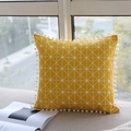 Yellow geometric lumbar pillow cover with white pom-poms on a fabric sofa - 45x45cm / Yellow Checkerboard with White Pom-poms