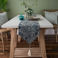 Runner da tavolo nordico blu navy con motivi geometrici e nappe su un tavolo in legno - 30x140 / Triangolo Blu Notte Con Nappe Bianche