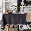 Dark grey rectangular tablecloth with white pom-pom fringe in a cozy home setting - 100x140cm / Gray With White Pom-poms