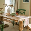 Linen table runner with red diamond patterns and fringe on a rustic wooden dining table - Red Grid Hemp