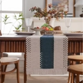 Nordic navy blue and beige woven table runner with tassels on a wooden dining table - 33x120