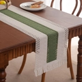 Olive green and cream hand-woven table runner with elegant tassels on a wooden table - Light Green Center