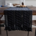 Navy blue woven table runner with intricate hollow textures and fringe trim - Cable Black