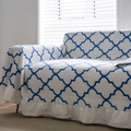 Modern white sofa cover with blue clover geometric pattern and decorative ruffled edges - Blue Diamond Ruffle