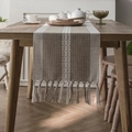 Camino de mesa boho con bordado geométrico y flecos hechos a mano sobre mesa de madera - 33x140 Camino de Mesa / Línea Única Café + Borlas Hechas a Mano