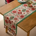 Floral table runner with vibrant red flowers and colorful tassels on wooden surface - Pink Flower