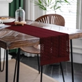 Burgundy crocheted table runner with hollow patterns and long tassels on wooden table - 33cm x 160cm / Braided Burgundy Fringe / Burgundy