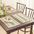 Bohemian woven placemat with green stripes and tassels on dark wood table - Light Green Stripes