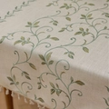 In-depth view of linen tablecloth with green vine embroidery and white fringe edges - 100x140cm / Green Ivy