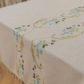 Linen table cloth with blue floral embroidery and fringe tassels in beige color - 100-140