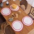 Set of four minimalist round white cotton linen placemats with red wavy scalloped edges - Red Line