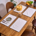 Set of 4 white rectangular placemats with blue pom-pom trim on a wooden table - Gray Line
