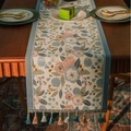 Elegant floral jacquard table runner with blue and yellow tassels on a dark wood table - 35-120 / Blue Pink Camellia