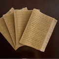 Set of 4 natural golden woven placemats with fringe on a dark wood table - Straw Yellow Twill Fringe