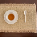 Natural woven rectangular table runner with tassels on a dark wood background - Khaki Woven Coffee Hemp Fringe
