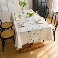 Off-white floral embroidery tablecloth with tassel edges in a warm dining room setting - Blue Pumpkin Flower Embroidery (Zhong Jian Xiu Hua Lan Se Nan Gua Hua Mi Sao Ba) / 100cmx140cm