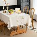 Beige floral embroidered linen tablecloth with delicate fringe trim on a wooden table - Hoya & Green Leaves Embroidery (Zhong Jian Xiu Hua Qiu Lan Lv Ye Mi Sao Ba) / 100cmx140cm
