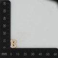 Detail shot of golden letter B charm with zircon pavé showing 11mm height measurement - Gold B